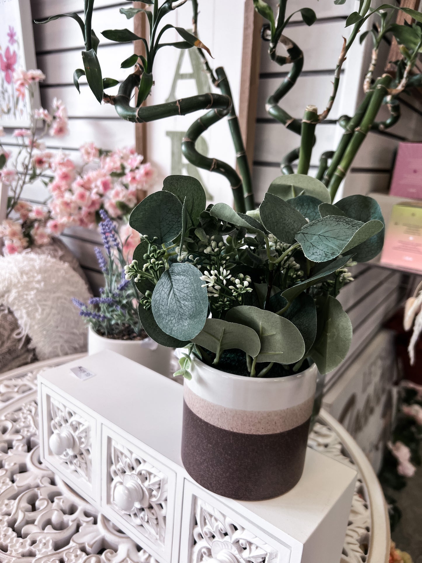Artificial plant in brown & white pot